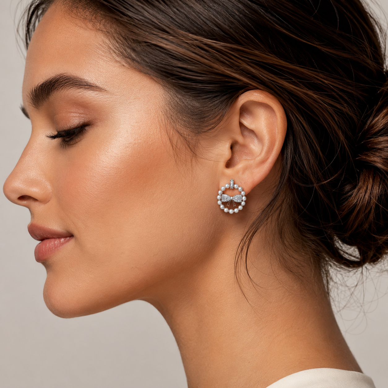 Close-up of a woman wearing a bow-shaped earring