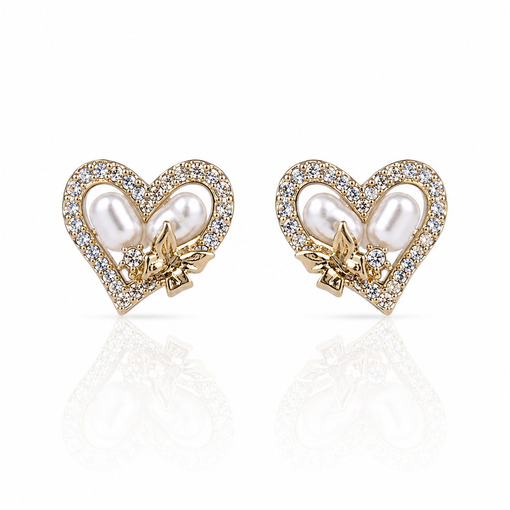 Heart-shaped earrings with pearls and gold accents and diamonds