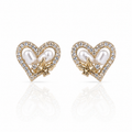 Heart-shaped earrings with pearls and gold accents and diamonds