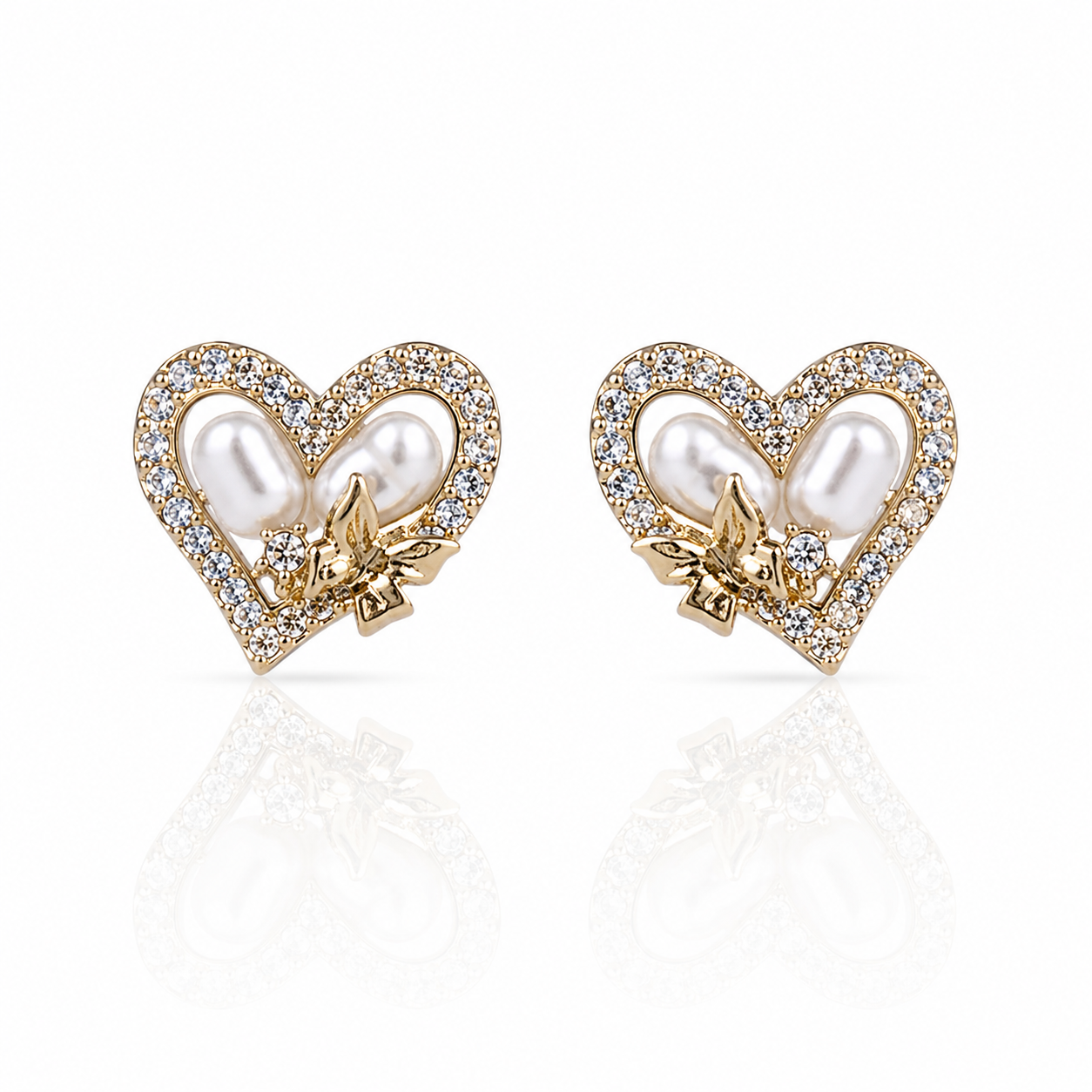 Heart-shaped earrings with pearls and gold accents and diamonds