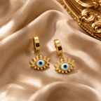 Gold hoop earrings with eye-shaped charms