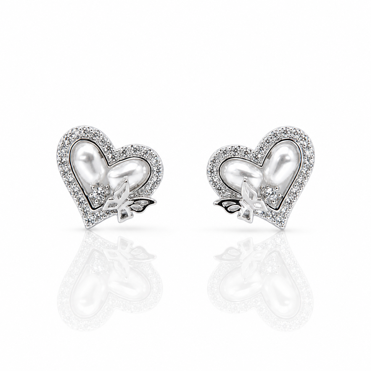 Heart-shaped earrings with pearl center and butterfly design