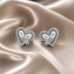 Heart-shaped earrings with pearl center and butterfly design