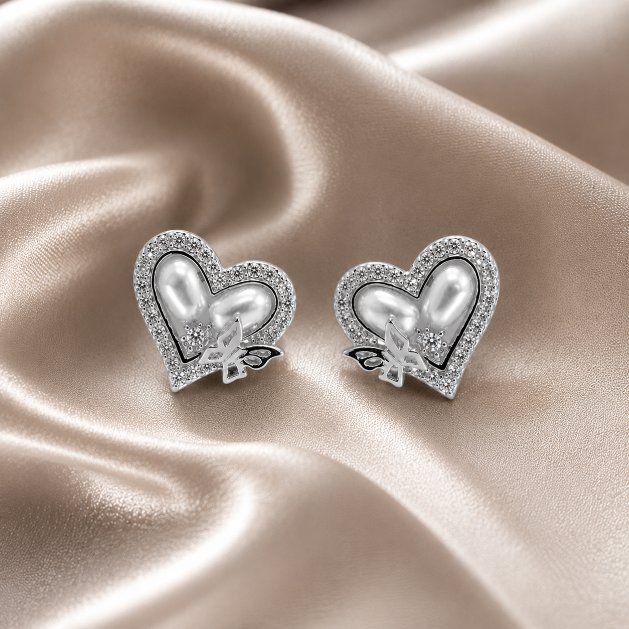 Heart-shaped earrings with pearl center and butterfly design