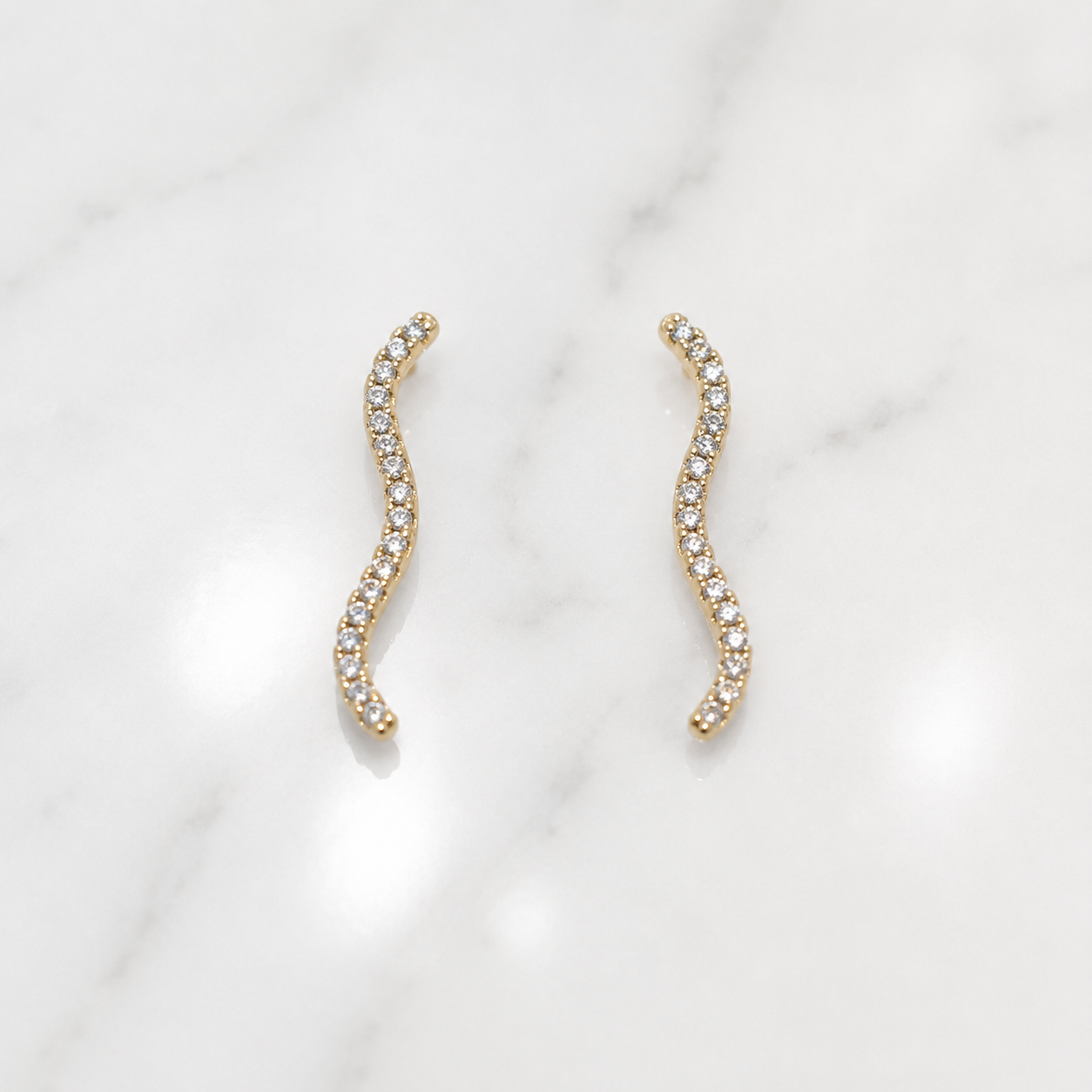 Gold earrings with a wavy design