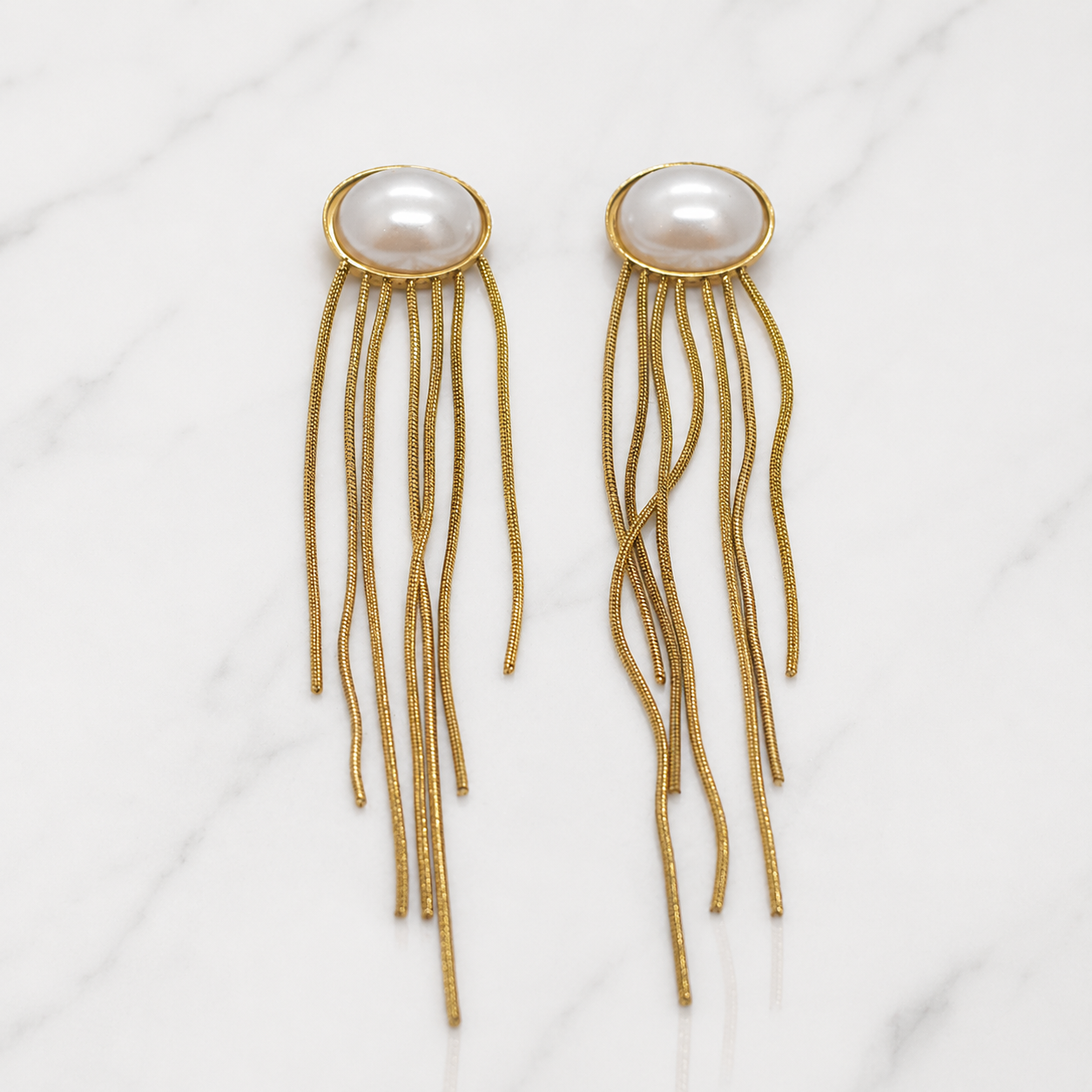 Gold-fringed earrings with pearl centers