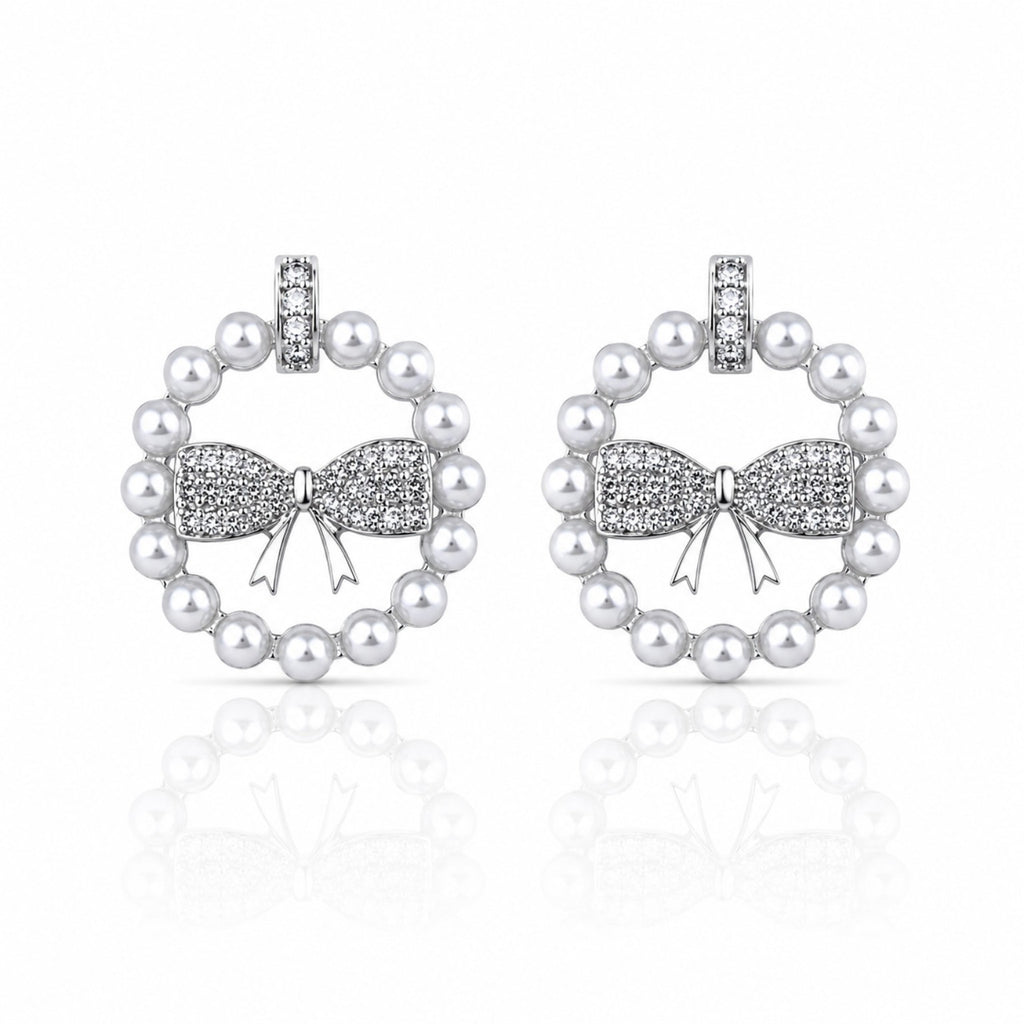 Pearl earrings with bow design