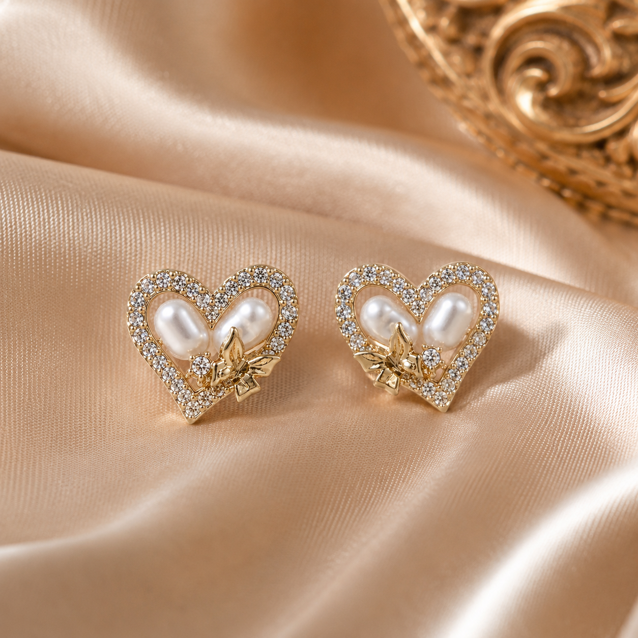 Heart-shaped earrings with pearls and gold accents and diamonds